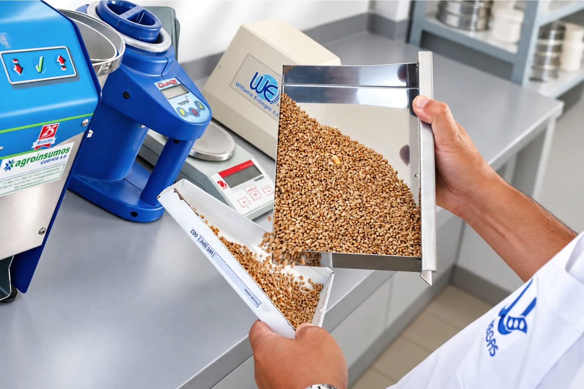 Lab technician measuring moisture and sieving a soybean sample.